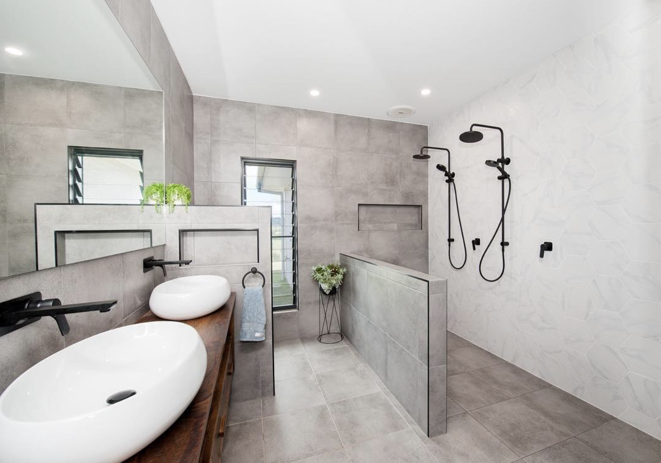 Modern grey-tiled bathroom with twin basins and walk-in shower, finished by R J Britt Painting, painters in Casino