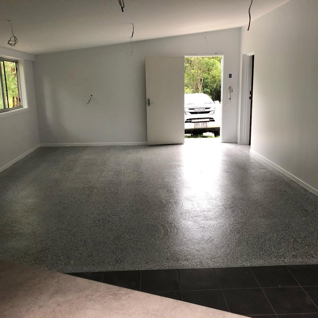 Freshly painted white interior with a grey flake epoxy garage floor completed by R J Britt Painting, painters in Tweed Heads
