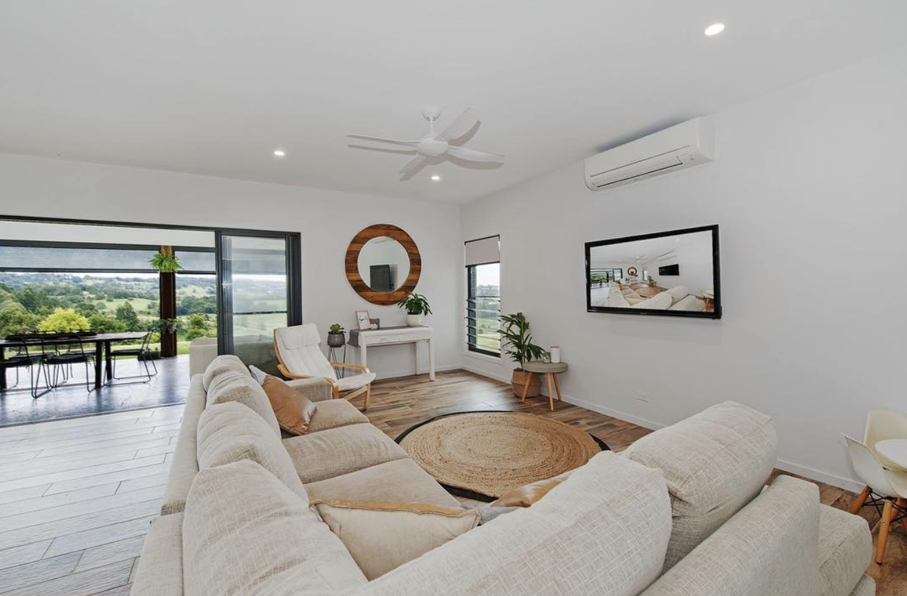 Freshly painted white open-plan living room with timber floors and hinterland views by R J Britt Painting in Lismore, NSW