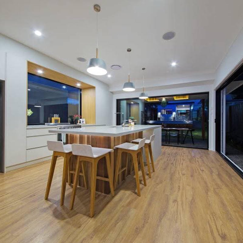 Open-plan kitchen and living area with freshly painted white walls, ceiling and timber island bench painted by R J Britt Painting in Ballina