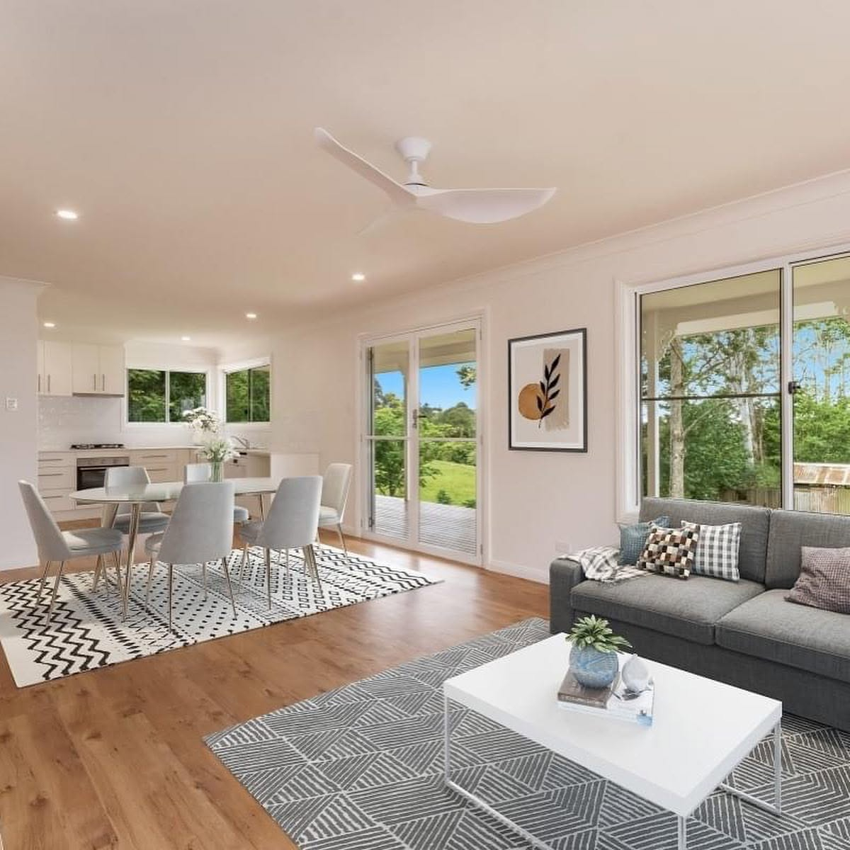Freshly painted open-plan living and dining room with white walls and timber floors by R J Britt Painting in Lismore, NSW