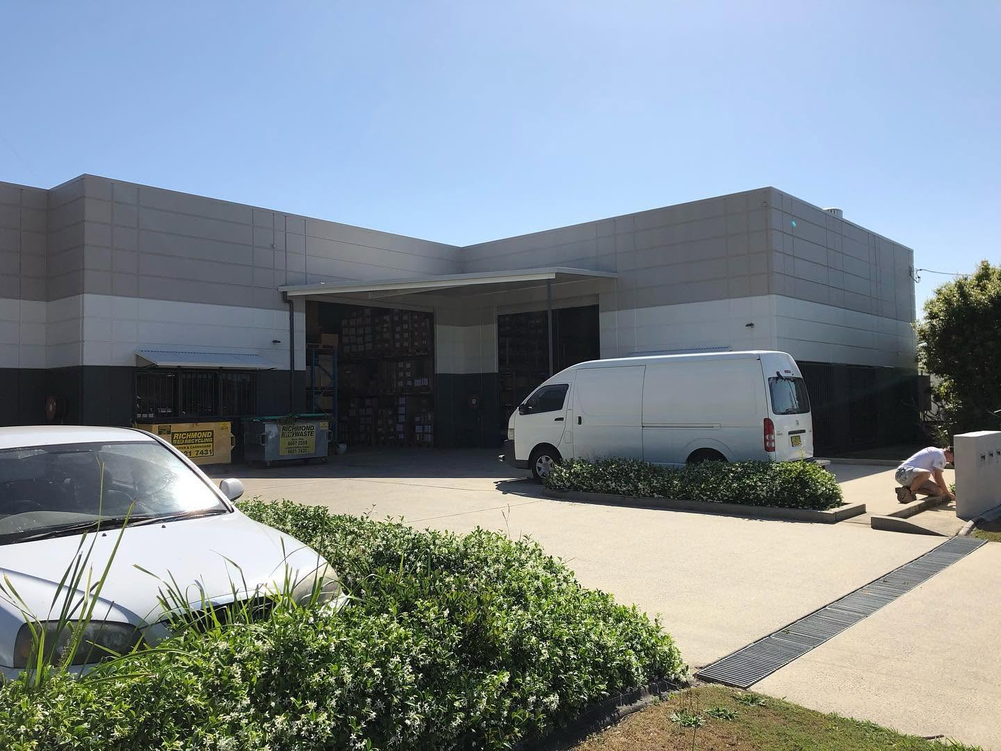Commercial painting of a warehouse facade and loading dock in grey and white by R J Britt Painting in Lismore, NSW