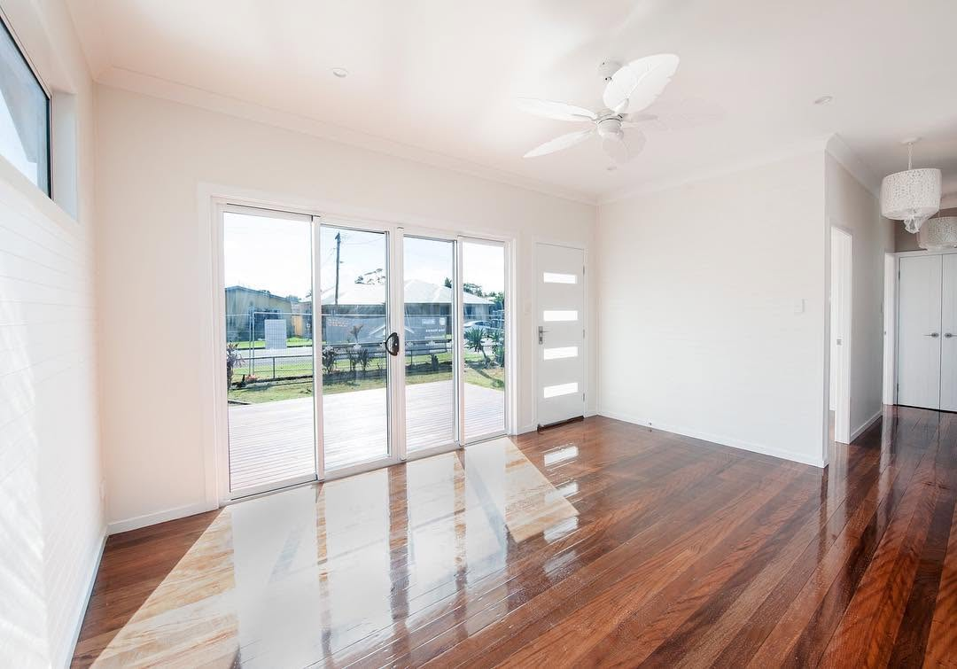 Bright white living room with glossy polished timber floors and freshly painted walls by R J Britt Painting in Lismore, NSW