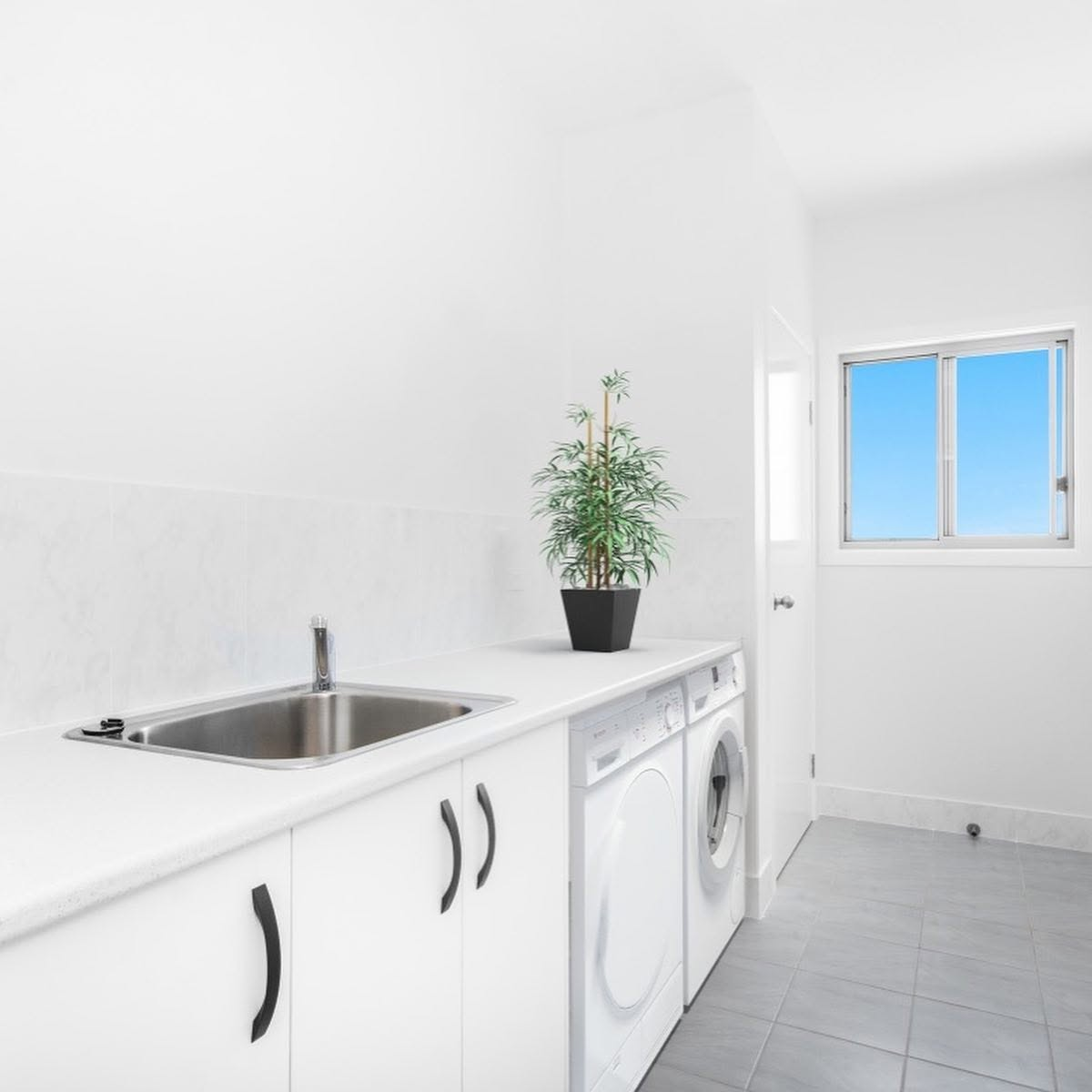 Interior repaint of a laundry with white walls, cabinetry and trim by R J Britt Painting in Lismore, NSW