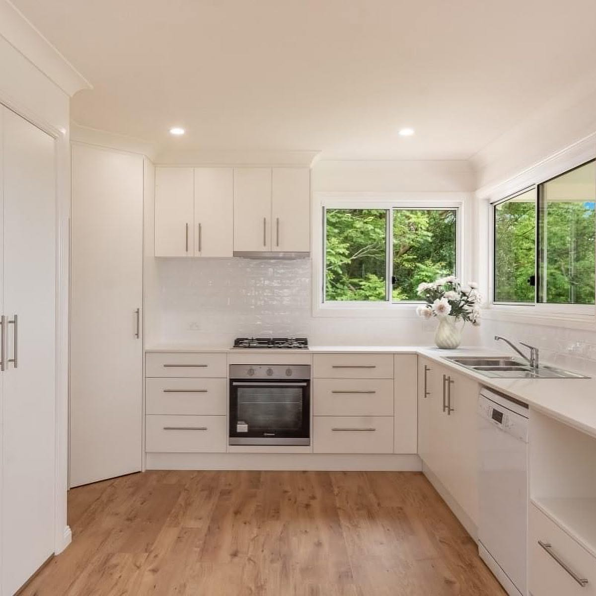 Freshly painted white kitchen interior with timber floors by R J Britt Painting in Lismore, NSW