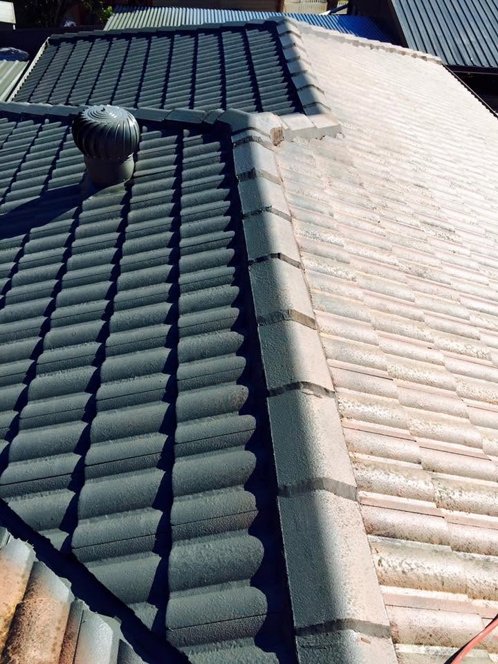 Roof restoration in progress with tile roof recoated in charcoal by R J Britt Painting in Lismore, NSW